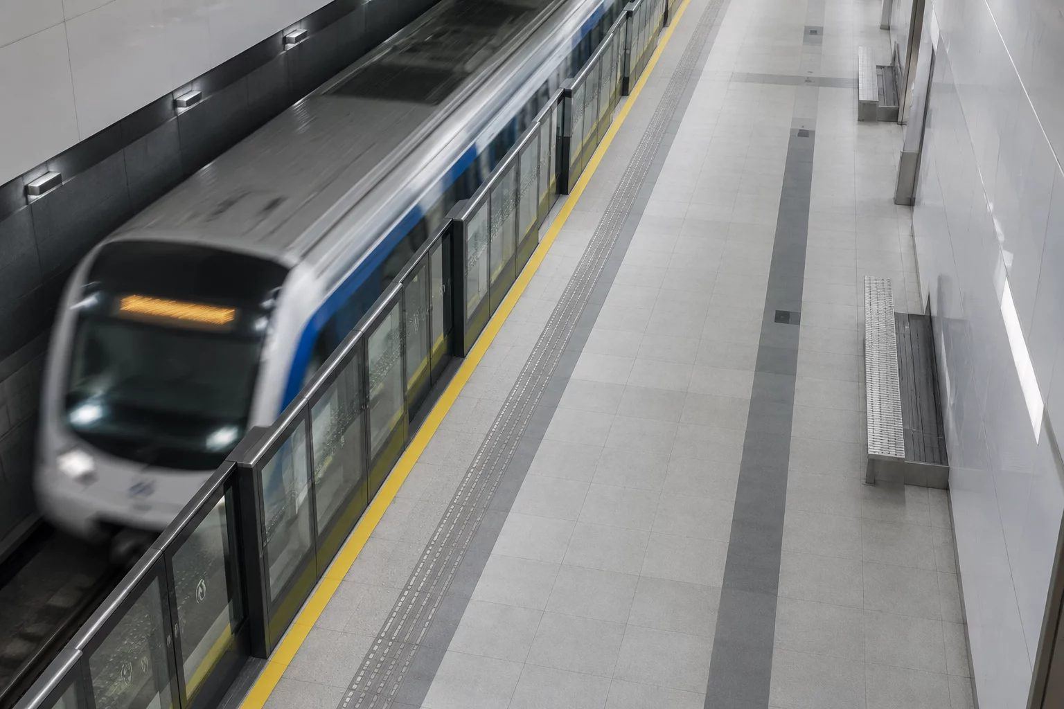 An empty metro platform as a train arrives